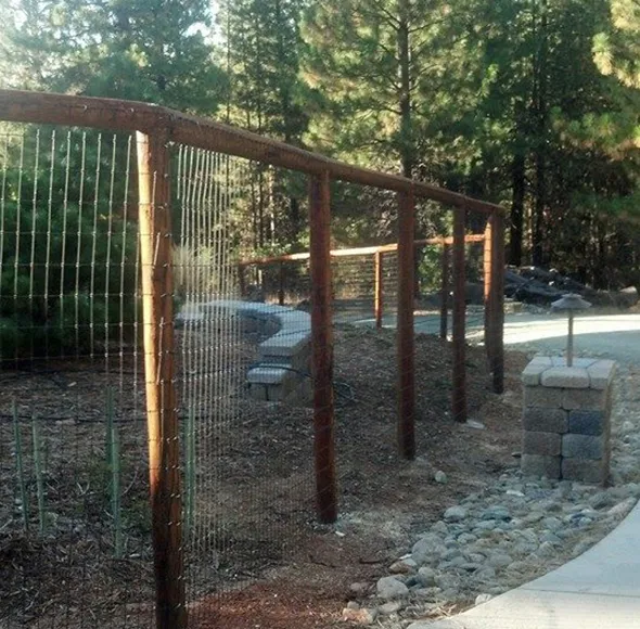 A hillside under construction, featuring erecting a new fence to define the property boundary and enhance security.
